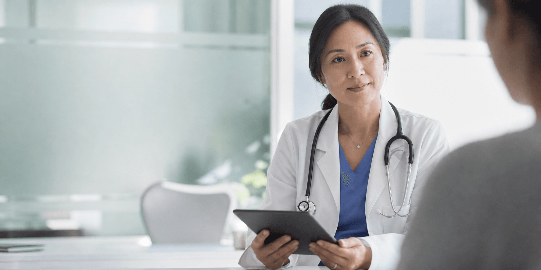 A physician discussing care with a patient